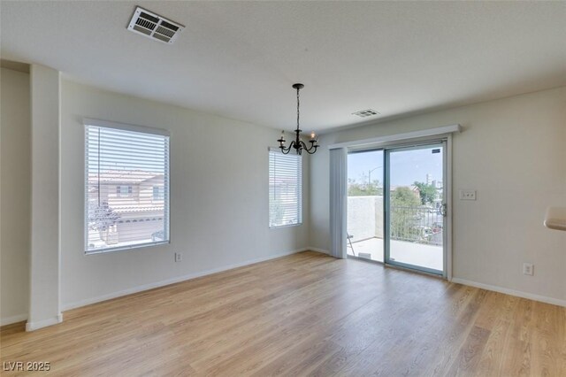 11668 Tierney Creek Dr, Las Vegas, NV 89183 - empty room featuring a chandelier, light wood-style flooring, and baseboards