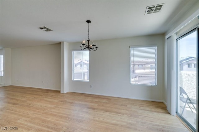 11668 Tierney Creek Dr, Las Vegas, NV 89183 - unfurnished room with a chandelier, light wood-style flooring, and baseboards