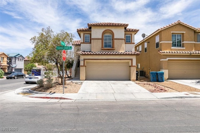 11668 Tierney Creek Dr, Las Vegas, NV 89183 - view of front of home with stucco siding, a tile roof, an attached garage, and concrete driveway