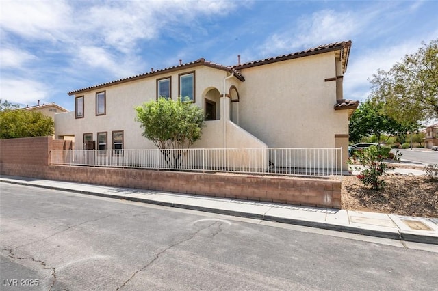 11668 Tierney Creek Dr, Las Vegas, NV 89183 - mediterranean / spanish home with fence, stucco siding, and a tile roof