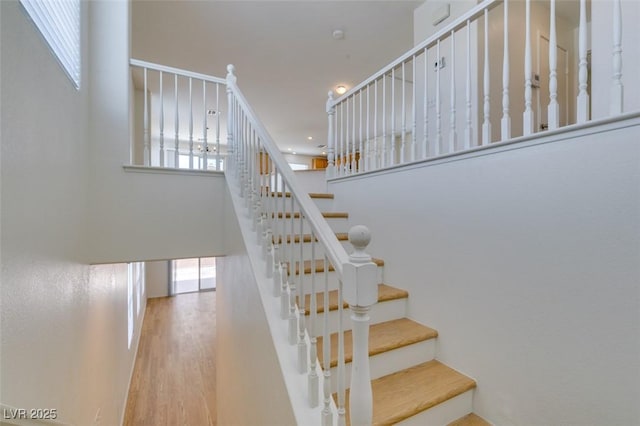 11668 Tierney Creek Dr, Las Vegas, NV 89183 - stairs featuring wood finished floors and a high ceiling