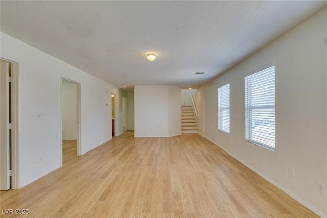 11668 Tierney Creek Dr, Las Vegas, NV 89183 - unfurnished living room with light wood finished floors, stairs, and baseboards