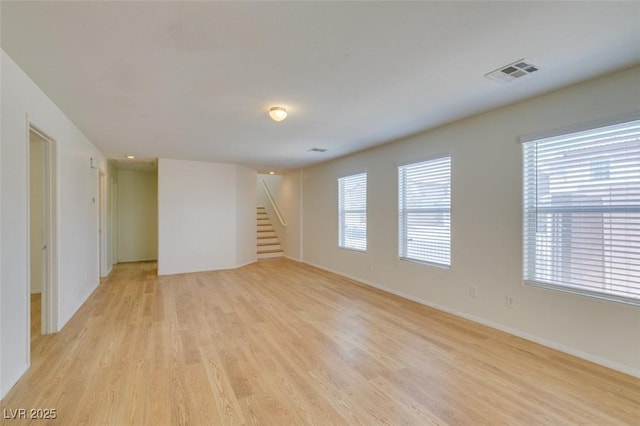 11668 Tierney Creek Dr, Las Vegas, NV 89183 - spare room with light wood-type flooring, stairs, healthy amount of natural light, and baseboards