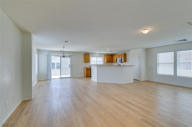 11668 Tierney Creek Dr, Las Vegas, NV 89183 - unfurnished living room with light wood-style floors, a chandelier, baseboards, and recessed lighting