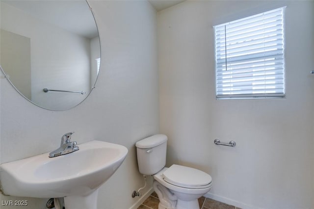 11668 Tierney Creek Dr, Las Vegas, NV 89183 - bathroom featuring baseboards, toilet, tile patterned floors, and a sink