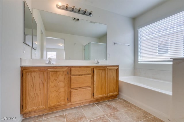 11668 Tierney Creek Dr, Las Vegas, NV 89183 - full bathroom featuring plenty of natural light, a stall shower, a bath, and double vanity