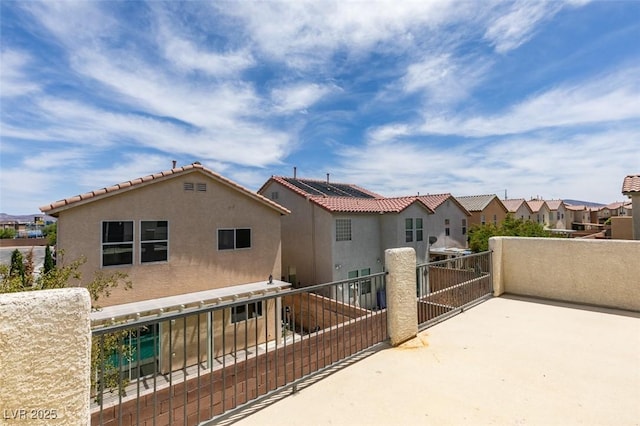 11668 Tierney Creek Dr, Las Vegas, NV 89183 - rear view of house featuring a balcony, stucco siding, and a residential view