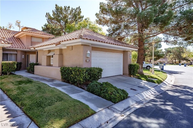 view of front of property featuring concrete driveway, an attached garage, a tiled roof, and stucco siding