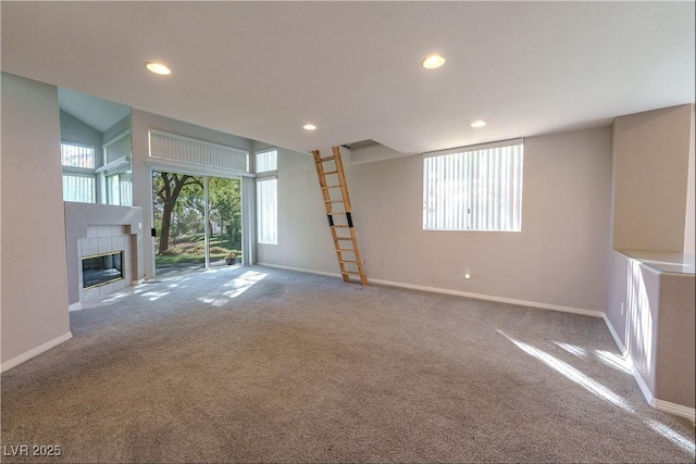 unfurnished living room with recessed lighting, carpet, and baseboards