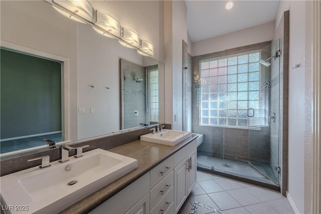bathroom featuring a stall shower and a sink