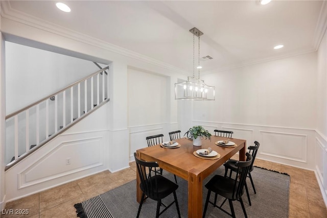 tiled dining space featuring recessed lighting, a decorative wall, crown molding, and stairs