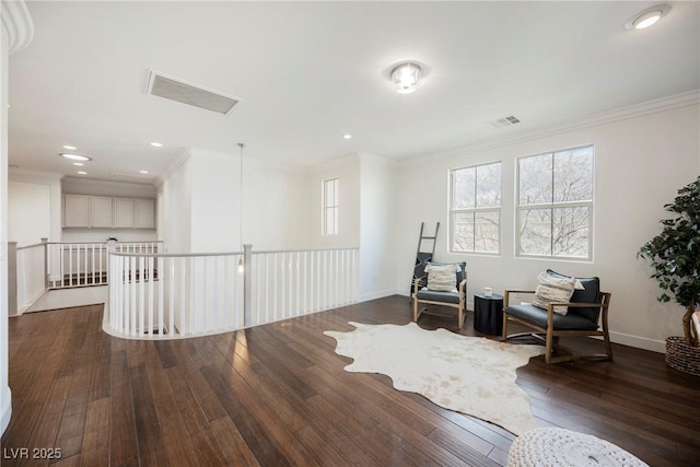 living area featuring dark wood-type flooring, visible vents, and crown molding