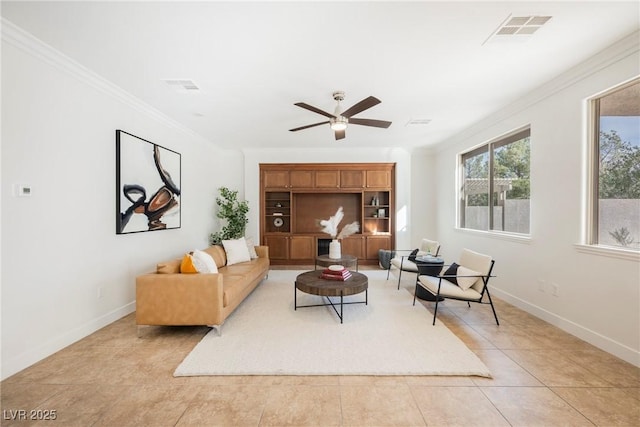 living room with ceiling fan, ornamental molding, visible vents, and light tile patterned floors