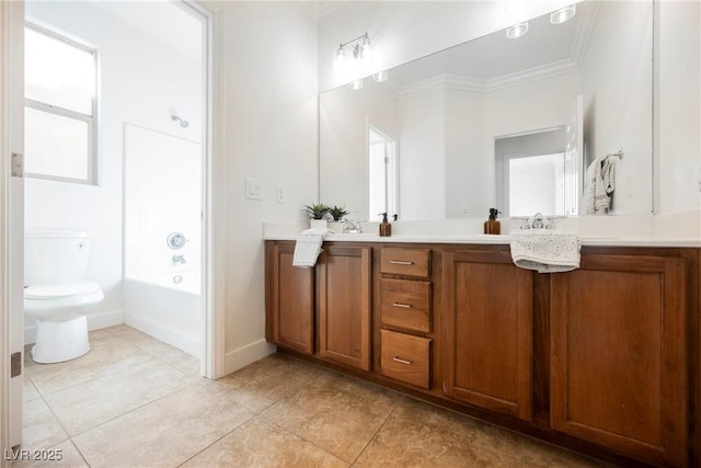 bathroom featuring tile patterned floors, double vanity, toilet, crown molding, and a tub