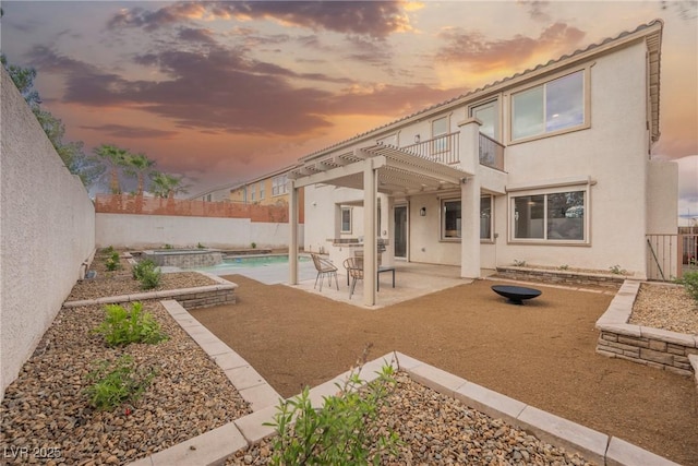 back of house with a patio, a fenced backyard, a pergola, and stucco siding