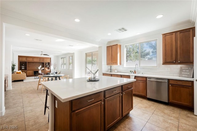kitchen with decorative backsplash, stainless steel dishwasher, visible vents, and light tile patterned floors