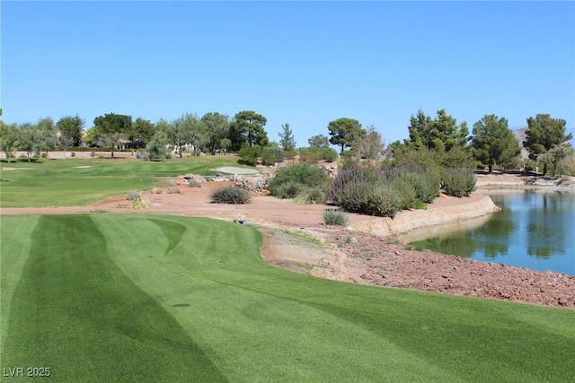 view of home's community featuring a yard, view of golf course, and a water view