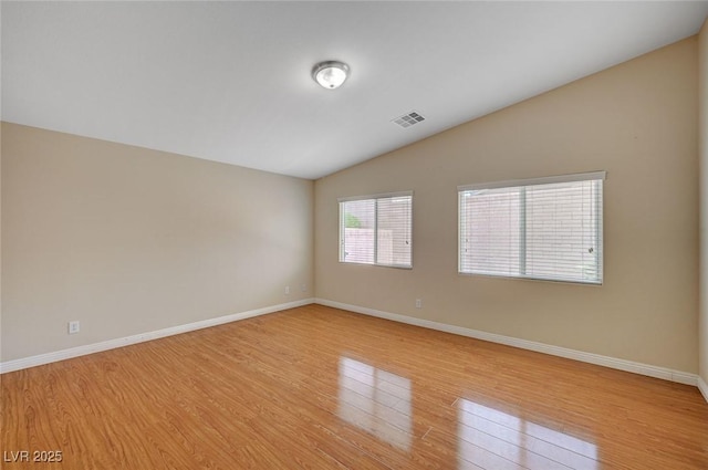 7822 Whitlocks Mill Ave, Las Vegas, NV 89147 - spare room with vaulted ceiling, light wood finished floors, and baseboards
