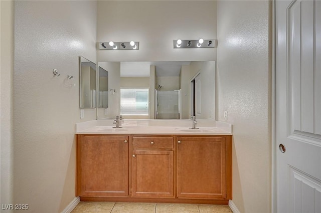 7822 Whitlocks Mill Ave, Las Vegas, NV 89147 - bathroom with double vanity, a shower with shower door, baseboards, and tile patterned floors