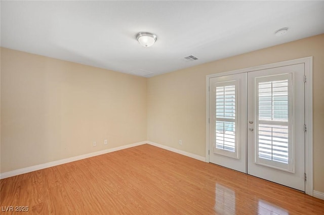 7822 Whitlocks Mill Ave, Las Vegas, NV 89147 - empty room with light wood-style floors, french doors, and baseboards