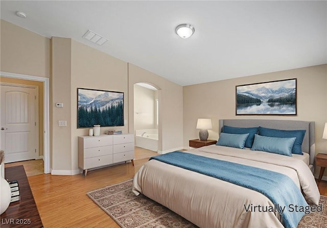 7822 Whitlocks Mill Ave, Las Vegas, NV 89147 - bedroom with light wood-style flooring, baseboards, and connected bathroom