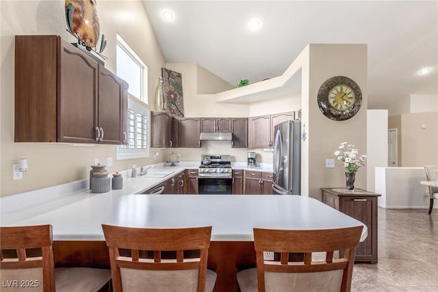 805 Blue Springs Dr, Henderson, NV 89002 - kitchen featuring a peninsula, a sink, light countertops, under cabinet range hood, and appliances with stainless steel finishes