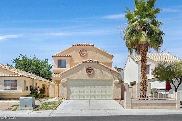 mediterranean / spanish-style house with a garage, a tile roof, stucco siding, and concrete driveway
