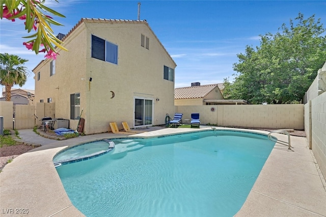 view of pool featuring a fenced backyard, a patio area, and a pool with connected hot tub
