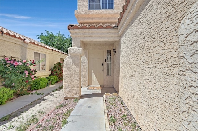 entrance to property with stucco siding