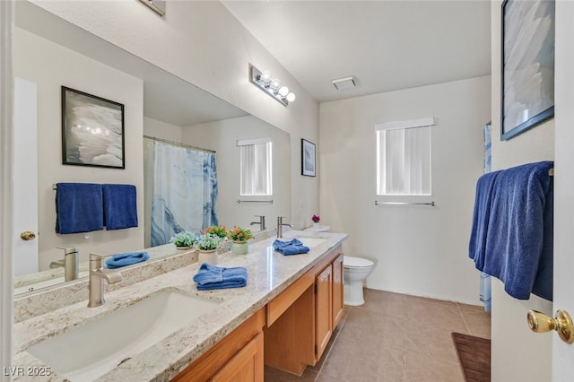 bathroom with toilet, tile patterned flooring, a sink, and visible vents