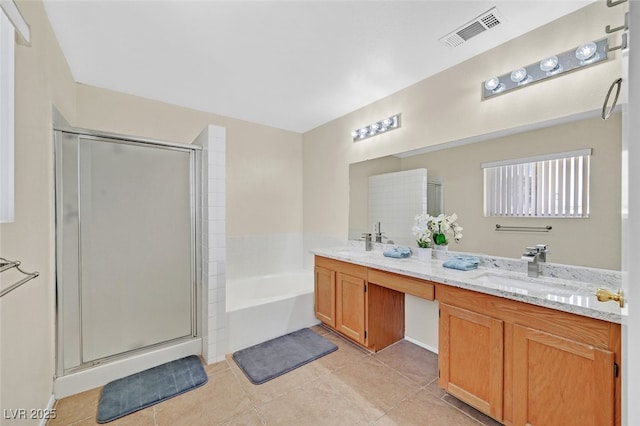 bathroom with tile patterned floors, a garden tub, visible vents, and a shower stall