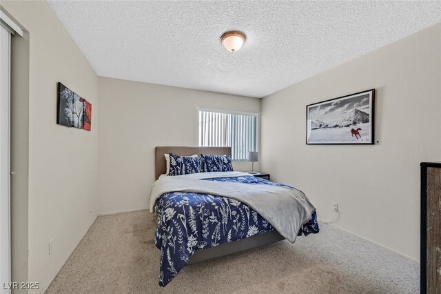 carpeted bedroom with a textured ceiling