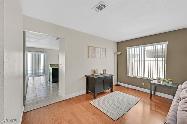 interior space featuring wood finished floors, visible vents, and baseboards
