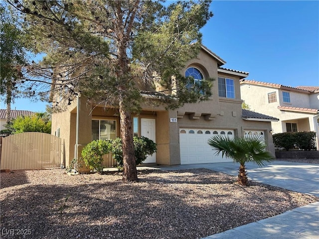 view of front of house featuring a gate, driveway, a garage, and stucco siding