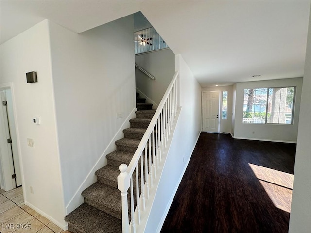 stairway featuring wood finished floors and baseboards