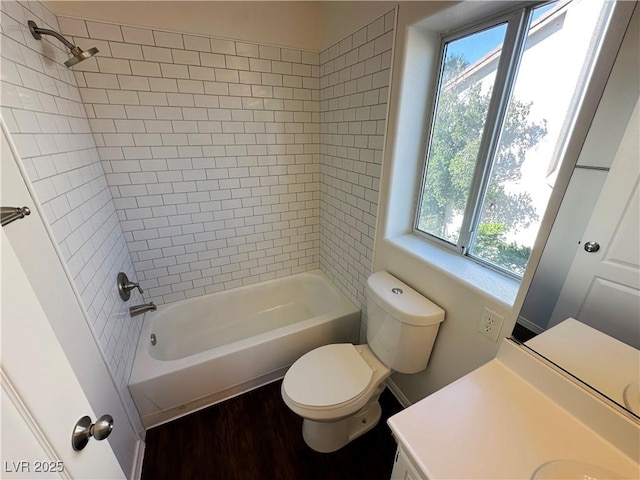 full bath featuring shower / bathing tub combination, wood finished floors, vanity, and toilet
