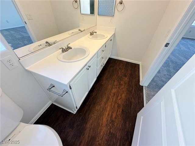 bathroom with wood finished floors and a sink