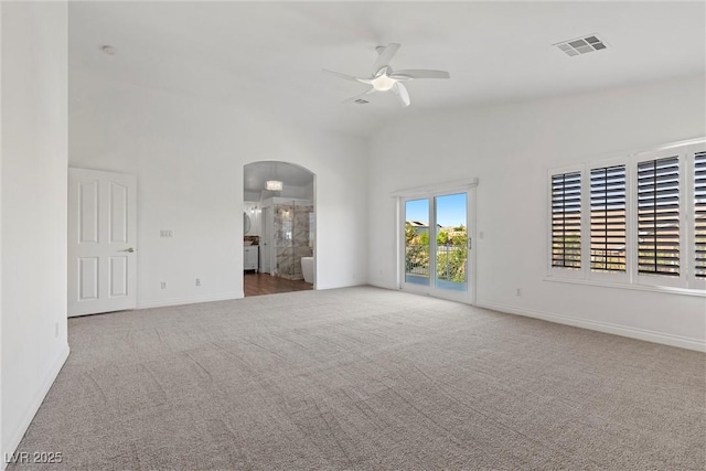 283 Grand Olympia Dr, Henderson, NV 89012 - empty room with ceiling fan, carpet floors, arched walkways, baseboards, and high vaulted ceiling