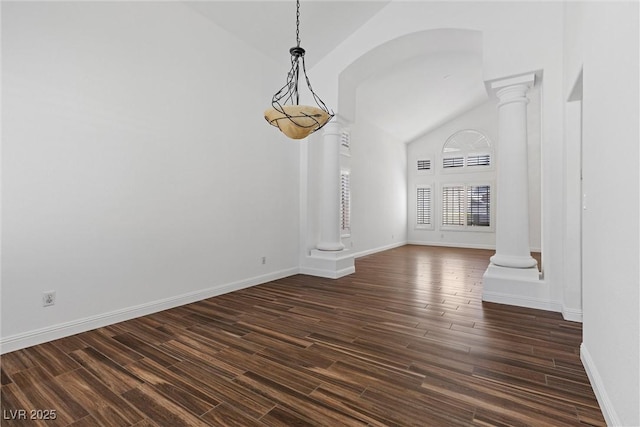 283 Grand Olympia Dr, Henderson, NV 89012 - unfurnished dining area with decorative columns, lofted ceiling, dark wood-type flooring, and baseboards