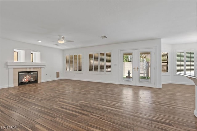 283 Grand Olympia Dr, Henderson, NV 89012 - unfurnished living room featuring a ceiling fan, wood finished floors, a tile fireplace, baseboards, and recessed lighting