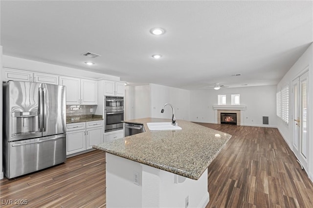 283 Grand Olympia Dr, Henderson, NV 89012 - kitchen featuring appliances with stainless steel finishes, a sink, a ceiling fan, white cabinetry, and recessed lighting