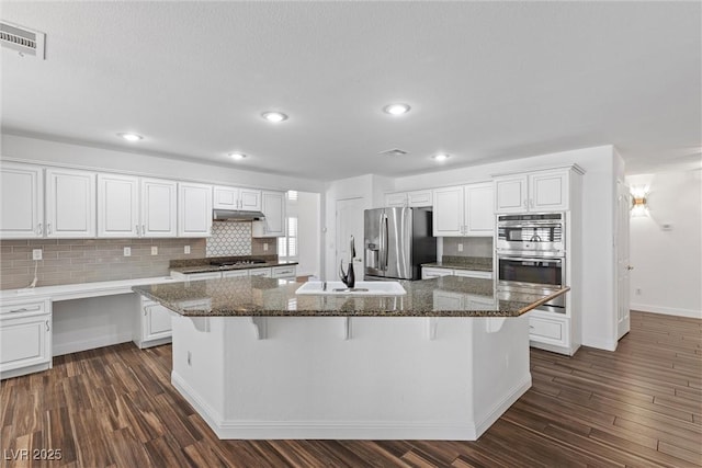 283 Grand Olympia Dr, Henderson, NV 89012 - kitchen with appliances with stainless steel finishes, a sink, tasteful backsplash, a center island, and under cabinet range hood