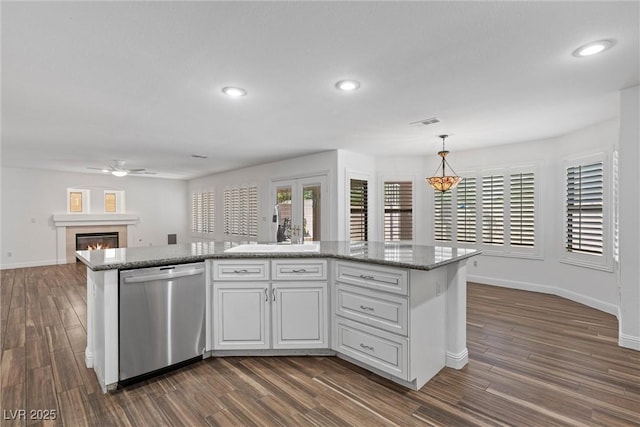 283 Grand Olympia Dr, Henderson, NV 89012 - kitchen with stainless steel dishwasher, a sink, a ceiling fan, baseboards, and dark wood-style floors