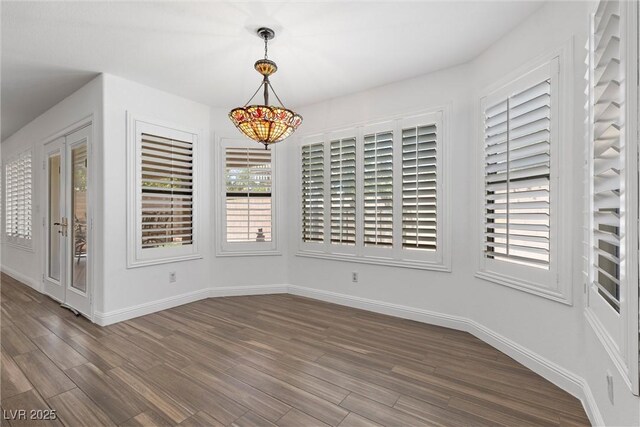 283 Grand Olympia Dr, Henderson, NV 89012 - unfurnished dining area with dark wood-type flooring and baseboards