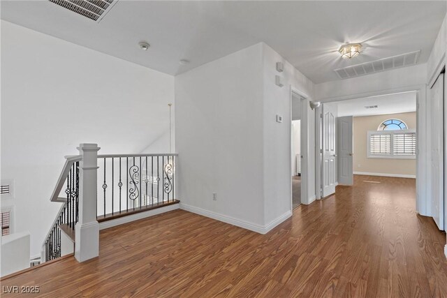283 Grand Olympia Dr, Henderson, NV 89012 - hallway featuring wood finished floors, baseboards, and an upstairs landing