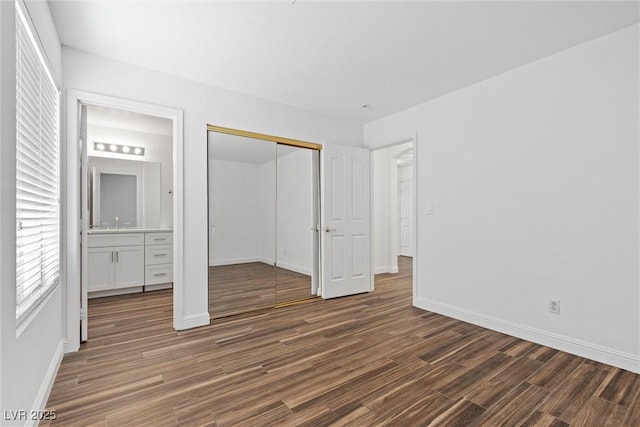 283 Grand Olympia Dr, Henderson, NV 89012 - unfurnished bedroom featuring wood finished floors, baseboards, and a closet