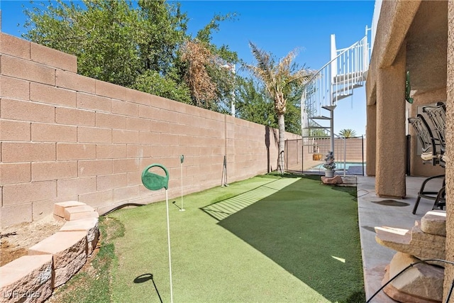 283 Grand Olympia Dr, Henderson, NV 89012 - fenced backyard featuring a putting area
