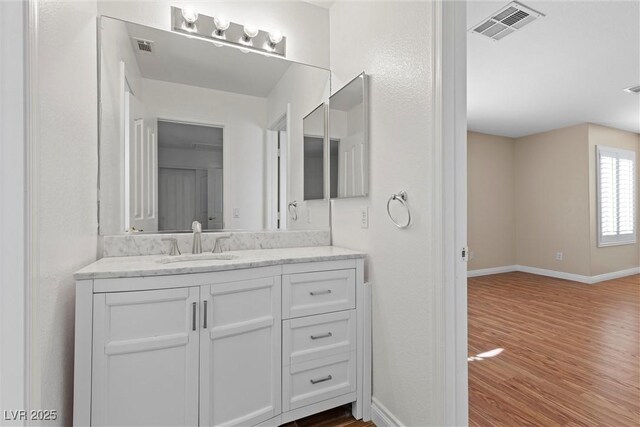 283 Grand Olympia Dr, Henderson, NV 89012 - bathroom with wood finished floors, baseboards, and vanity