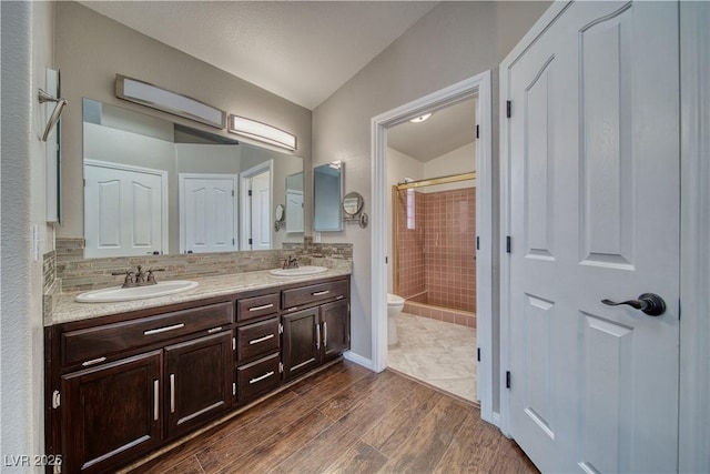151 Hornet St, Pahrump, NV 89048 - full bath featuring toilet, a stall shower, double vanity, wood finished floors, and vaulted ceiling