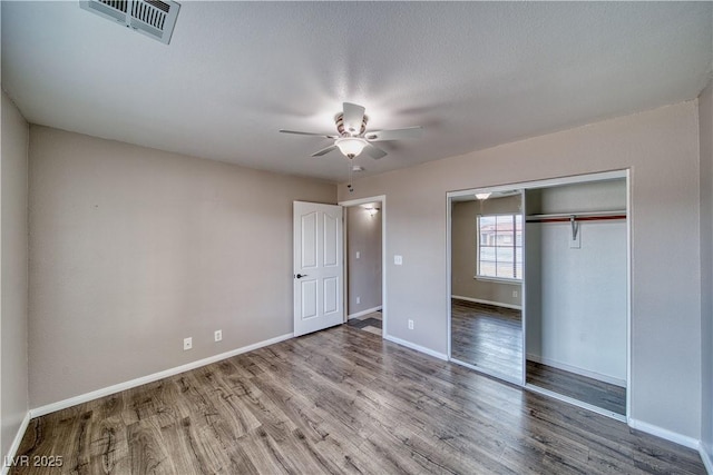 151 Hornet St, Pahrump, NV 89048 - unfurnished bedroom featuring wood finished floors, baseboards, a closet, and ceiling fan